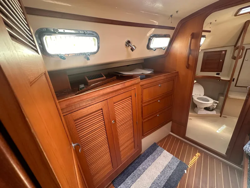 Slide: The Image of 2002 Island Packet 420 yacht interior with wooden cabinetry and bathroom. - 41