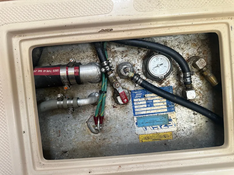 Slide: The Image of 2002 Island Packet 420 boat engine compartment with hoses and gauge. - 47