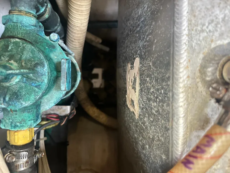 Slide: The Image of Engine compartment of a 2002 Island Packet 420 sailboat showing mechanical components. - 49