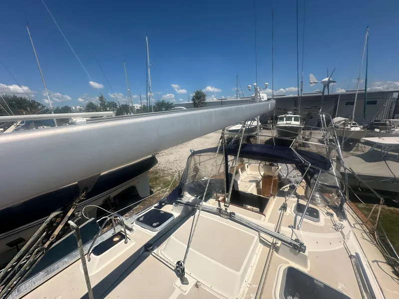 Slide: The Image of 2002 Island Packet 420 sailboat docked in a marina under a clear blue sky. - 9