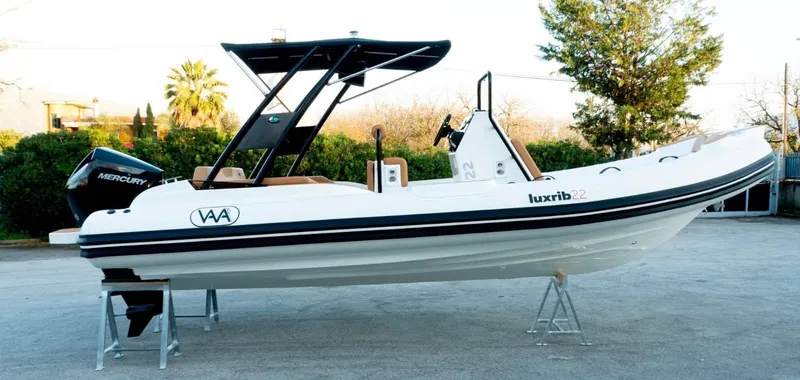 Slide: The Image of Aqvaboats Luxrib 22 (2025) white inflatable boat on stands, side view. - 16