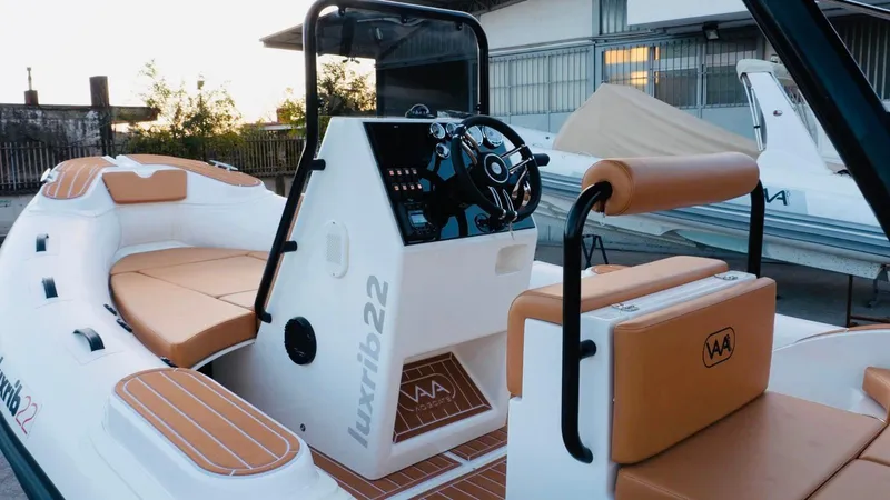 Slide: The Image of Aqvaboats Luxrib 22, 2025 model, luxury inflatable boat with tan seating and modern controls. - 20