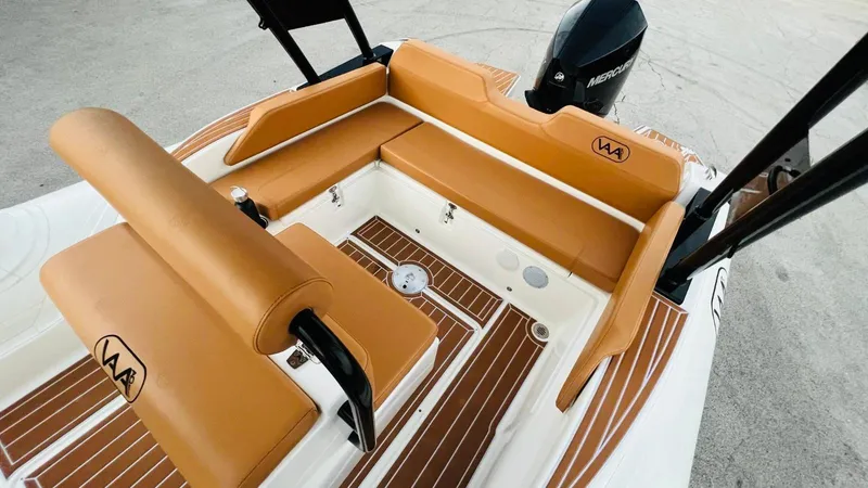 Slide: The Image of Aqvaboats Luxrib 22 (2025) with tan leather seating and wood deck. - 21