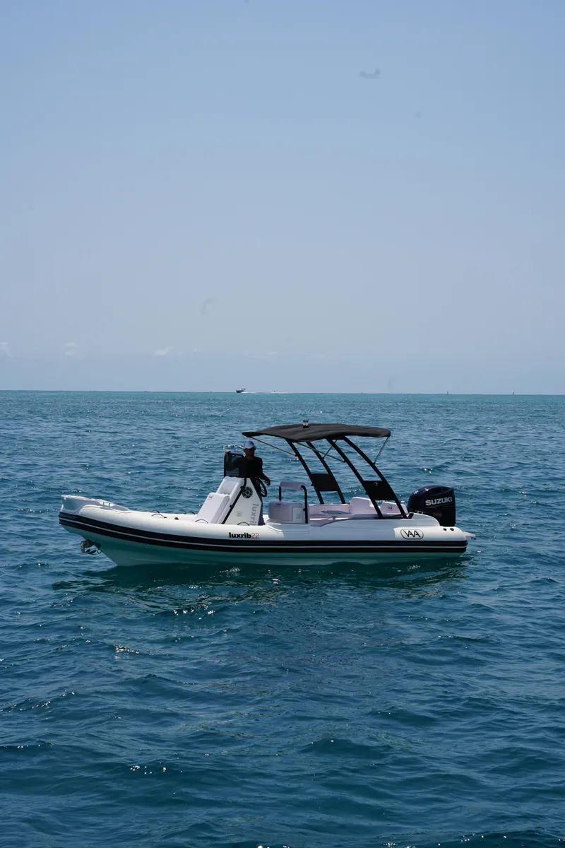 Slide: The Image of Aqvaboats Luxrib 22, 2025 model, floating on calm ocean waters. - 4