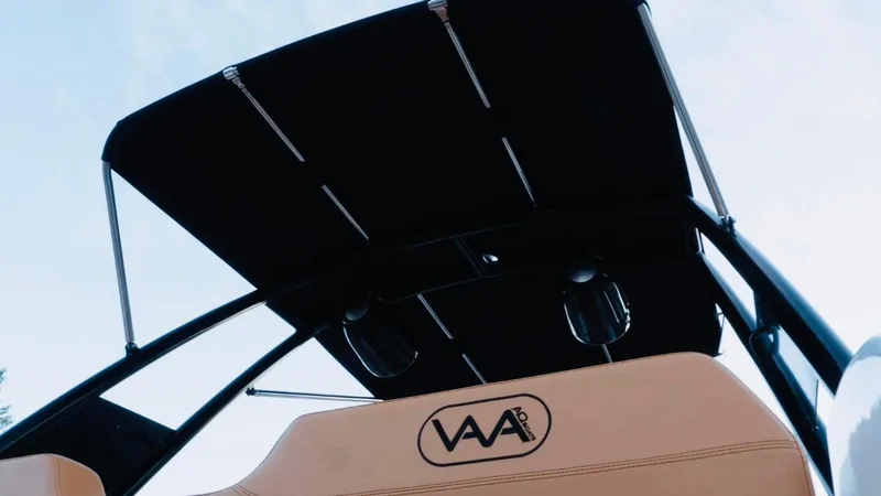 Slide: The Image of 2025 Aqvaboats Luxrib 22 with black canopy and beige seating. - 28