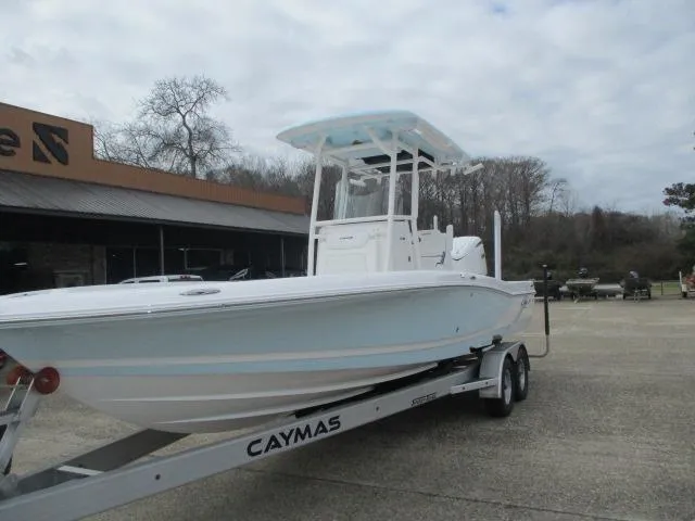 Slide: The Image of 2025 Caymas 26HB boat on trailer, parked outdoors, overcast sky. - 3