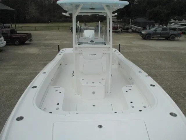 Slide: The Image of 2025 Caymas 26HB boat, spacious deck, center console, parked outdoors. - 4