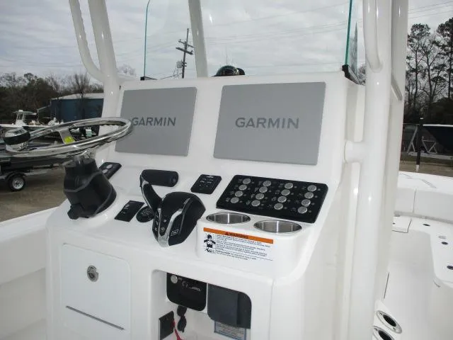 Slide: The Image of 2025 Caymas 26HB boat console with dual Garmin displays and steering wheel. - 6