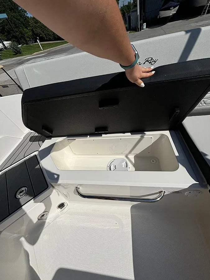 Slide: The Image of 2024 Sea Ray SPX 210 boat storage compartment with open lid. - 10