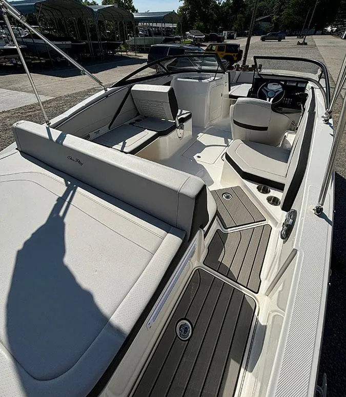 Slide: The Image of 2024 Sea Ray SPX 210 boat interior with seating and steering console. - 17