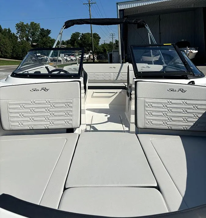 Slide: The Image of 2024 Sea Ray SPX 210 boat interior with white seating and dual consoles. - 19