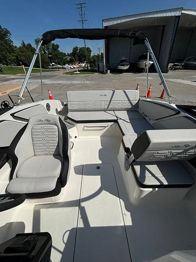 Slide: The Image of 2024 Sea Ray SPX 210 boat interior with seating and canopy. - 8
