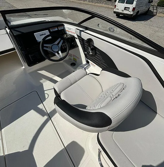 Slide: The Image of 2024 Sea Ray SPX 210 boat interior with steering wheel and captain's chair. - 9