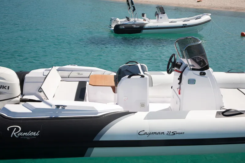 Slide: The Image of 2023 Ranieri Cayman 21 Sport boat on clear turquoise water. - 13
