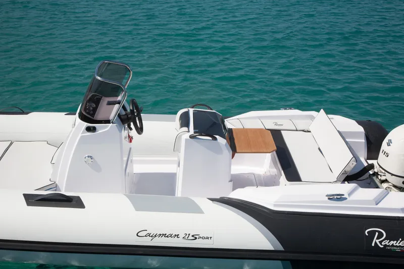 Slide: The Image of 2023 Ranieri CAYMAN 21 SPORT boat on clear blue water. - 14