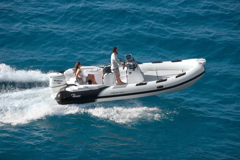 Slide: The Image of 2023 Ranieri CAYMAN 21 SPORT boat cruising on blue ocean water. - 4
