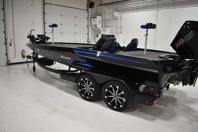 Slide: The Image of 2023 iKon LX21 black and blue fishing boat in a garage. - 3