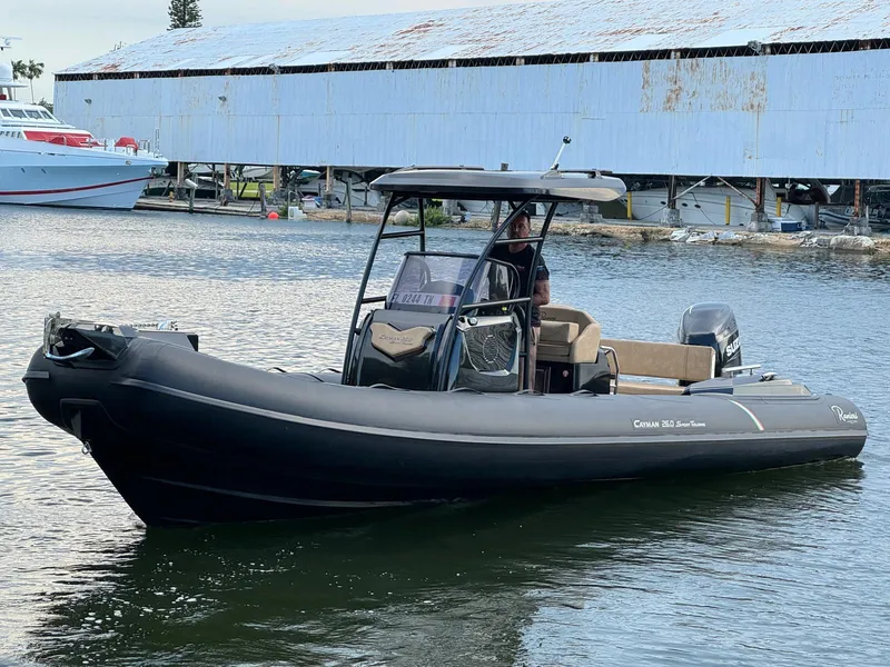 Slide: The Image of 2023 Ranieri CAYMAN 26 SPORT TOURING boat on water near dock. - 3