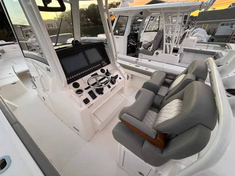 Slide: The Image of 2024 Regulator 34 boat interior with modern helm and cushioned seating. - 3