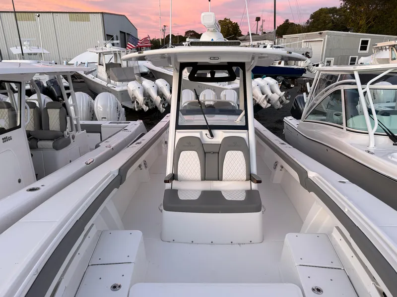 Slide: The Image of 2024 Regulator 34 boat interior with seating, docked at marina during sunset. - 6