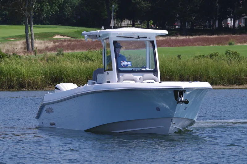 Slide: The Image of 2025 Everglades 285 Center Console boat cruising on a calm lake. - 10