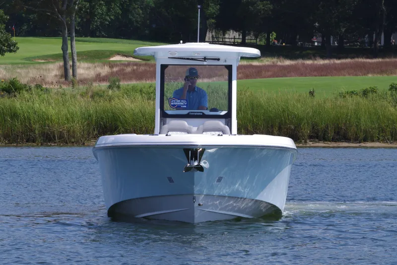 Slide: The Image of 2025 Everglades 285 Center Console boat on calm water, front view. - 11
