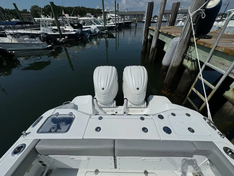 Slide: The Image of 2025 Everglades 285 Center Console boat docked at marina with twin engines. - 13