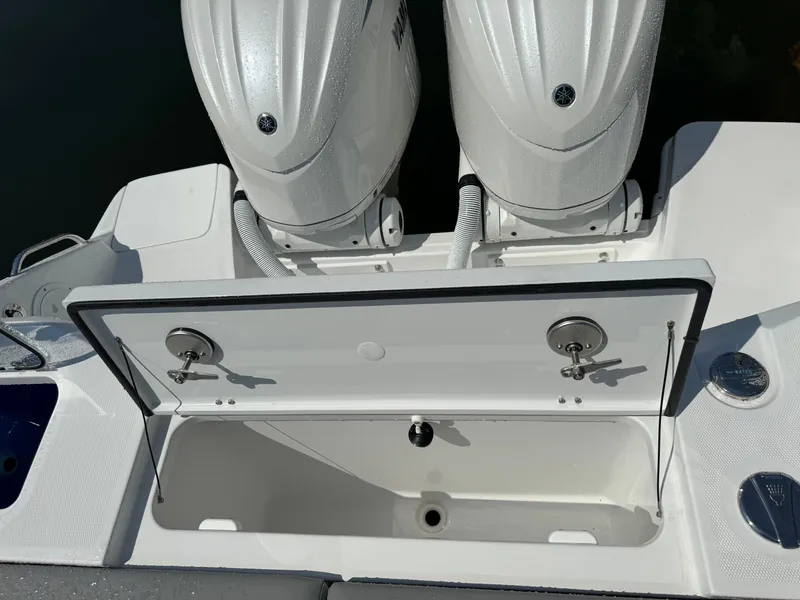 Slide: The Image of 2025 Everglades 285 Center Console boat with dual engines and open storage compartment. - 16