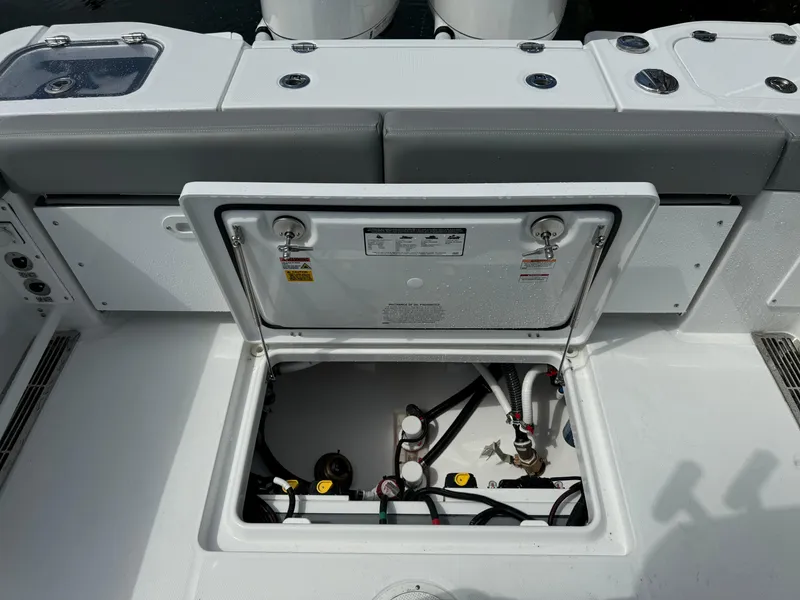 Slide: The Image of Open hatch on 2025 Everglades 285 Center Console boat, revealing internal components. - 20