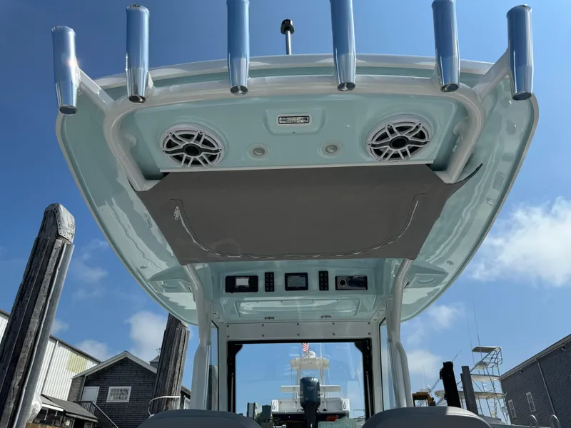 Slide: The Image of 2025 Everglades 285 Center Console boat interior with speakers and rod holders. - 24
