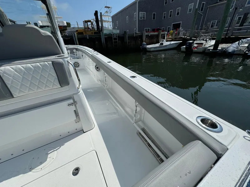 Slide: The Image of 2025 Everglades 285 Center Console boat docked, showcasing sleek interior and waterfront setting. - 28