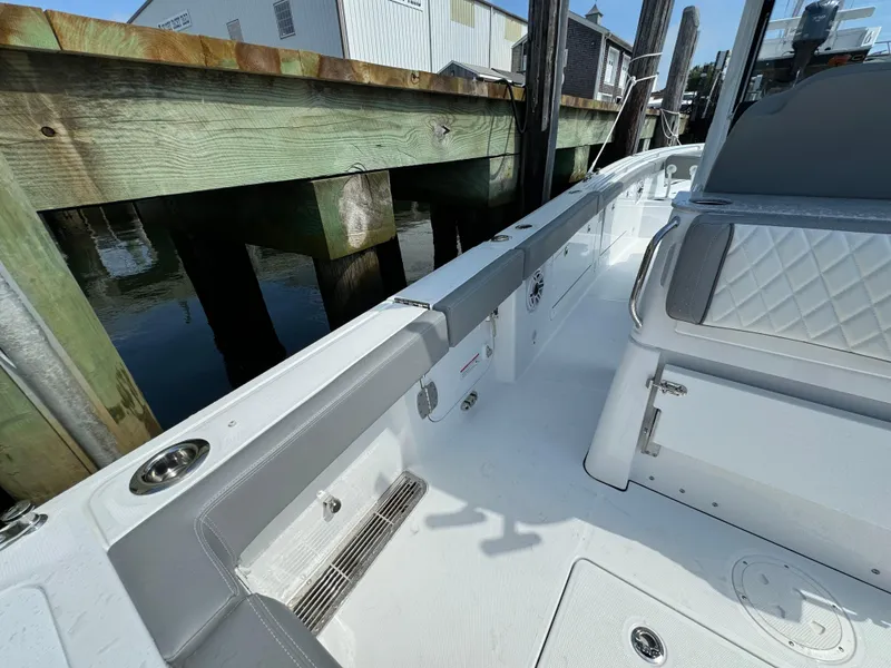 Slide: The Image of 2025 Everglades 285 Center Console boat docked, showcasing sleek interior design. - 29