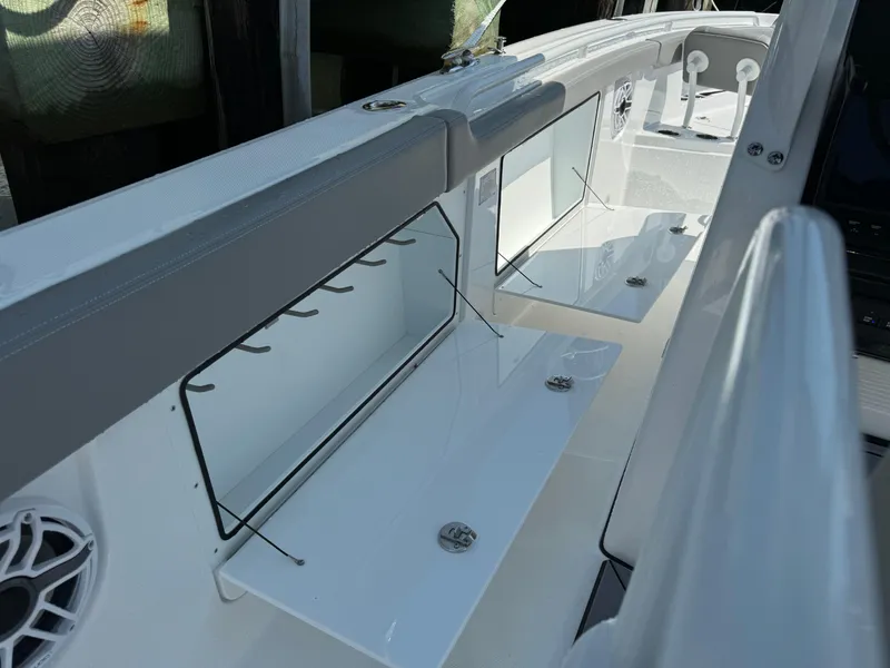 Slide: The Image of 2025 Everglades 285 Center Console boat interior with rod holders and storage compartments. - 31