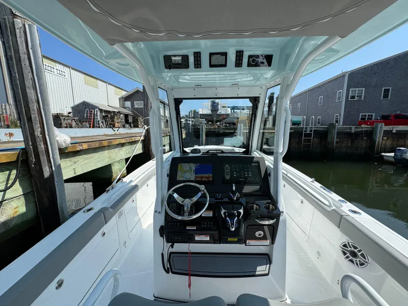 Slide: The Image of 2025 Everglades 285 Center Console boat interior at dock, featuring advanced navigation controls. - 33