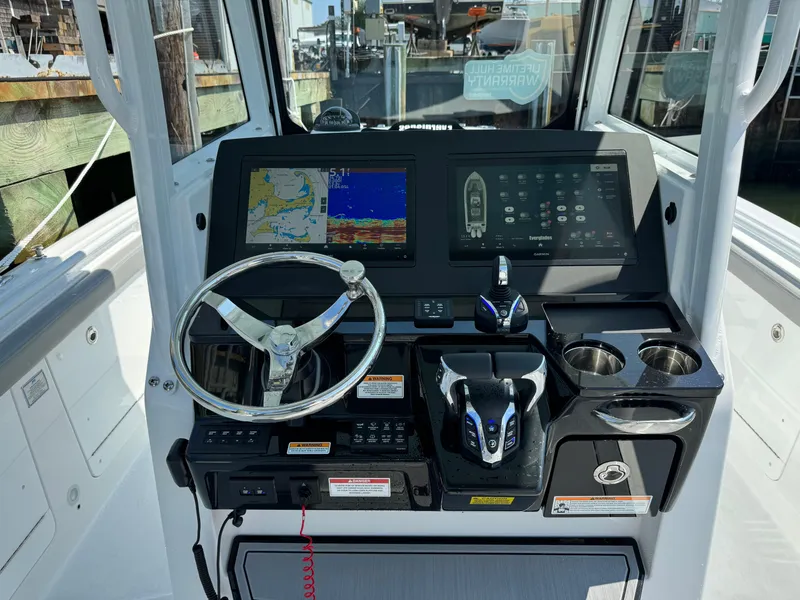 Slide: The Image of 2025 Everglades 285 Center Console boat dashboard with navigation screens and controls. - 34
