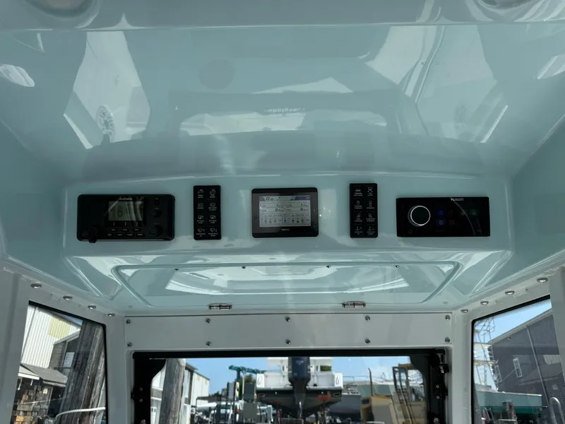 Slide: The Image of 2025 Everglades 285 Center Console boat dashboard with modern controls and navigation systems. - 35