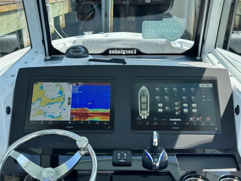 Slide: The Image of 2025 Everglades 285 Center Console boat dashboard with dual navigation screens. - 36