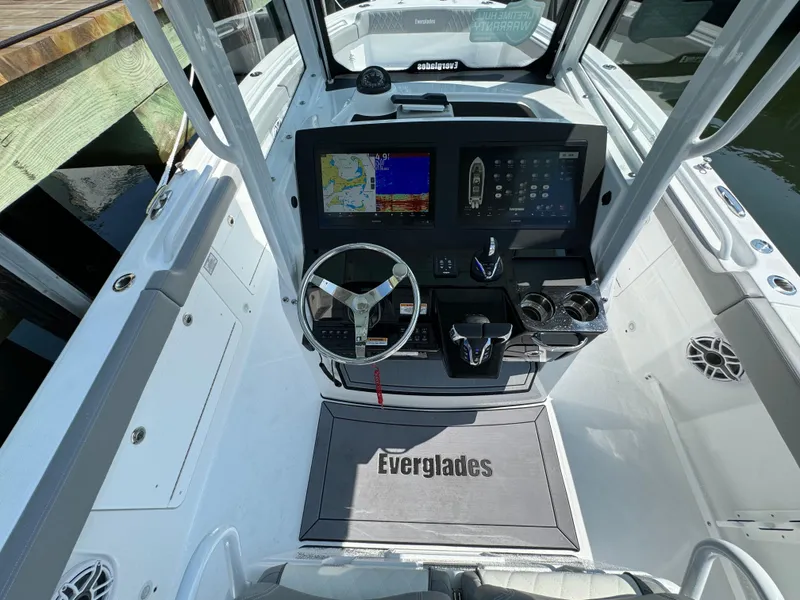 Slide: The Image of 2025 Everglades 285 Center Console boat dashboard with navigation system and steering wheel. - 37