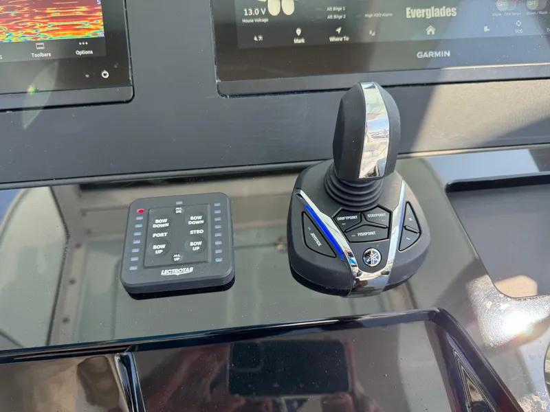 Slide: The Image of 2025 Everglades 285 Center Console boat controls with joystick and digital display. - 41