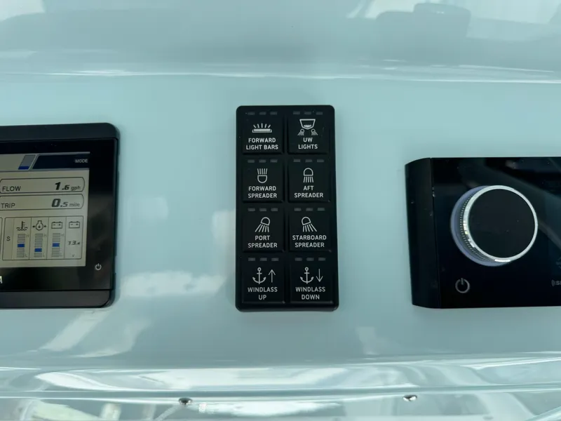 Slide: The Image of Control panel of 2025 Everglades 285 Center Console boat with various switches and dials. - 45