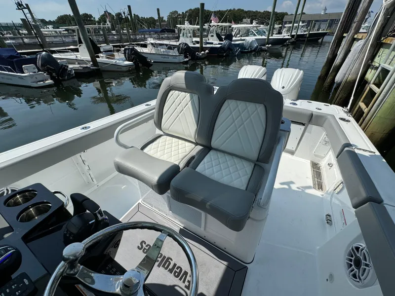 Slide: The Image of 2025 Everglades 285 Center Console boat interior with dual seats at marina. - 48