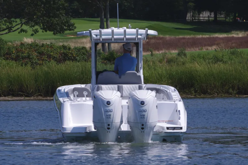 Slide: The Image of 2025 Everglades 285 Center Console boat on water, rear view. - 5