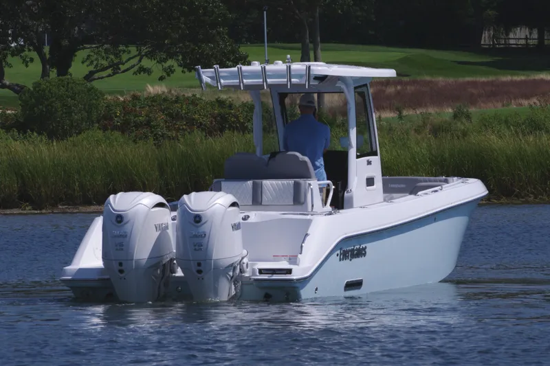 Slide: The Image of 2025 Everglades 285 Center Console boat on calm water with twin engines. - 6