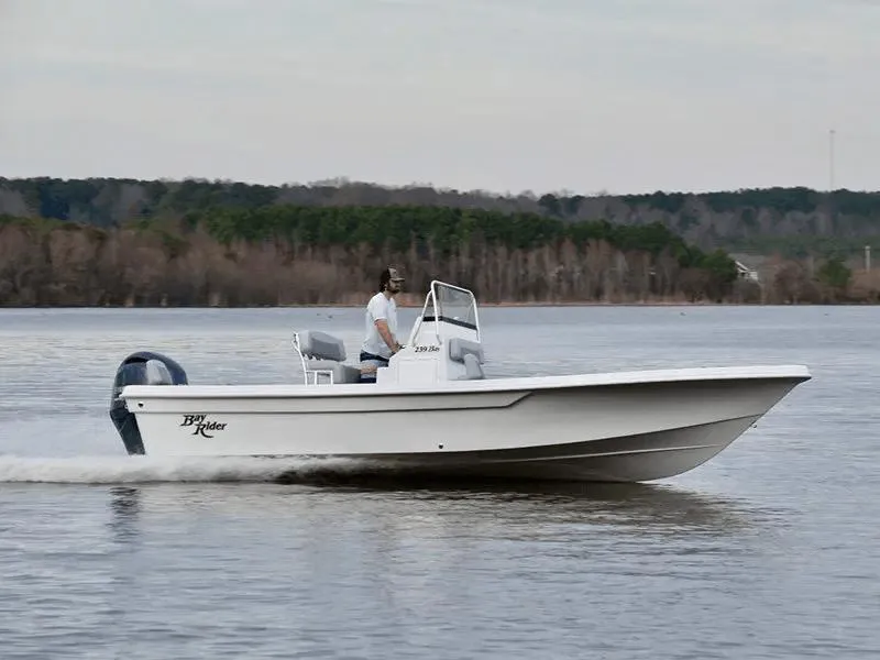 Slide: The Image of 2025 KenCraft 239 Bay Rider Bay boat cruising on a lake. - 2