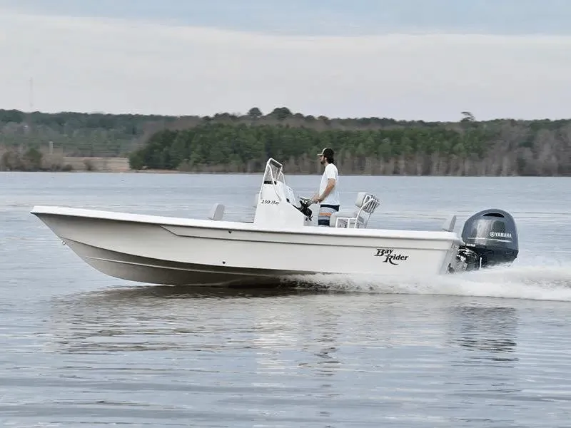 Slide: The Image of 2025 KenCraft 239 Bay Rider Bay boat cruising on a lake. - 3