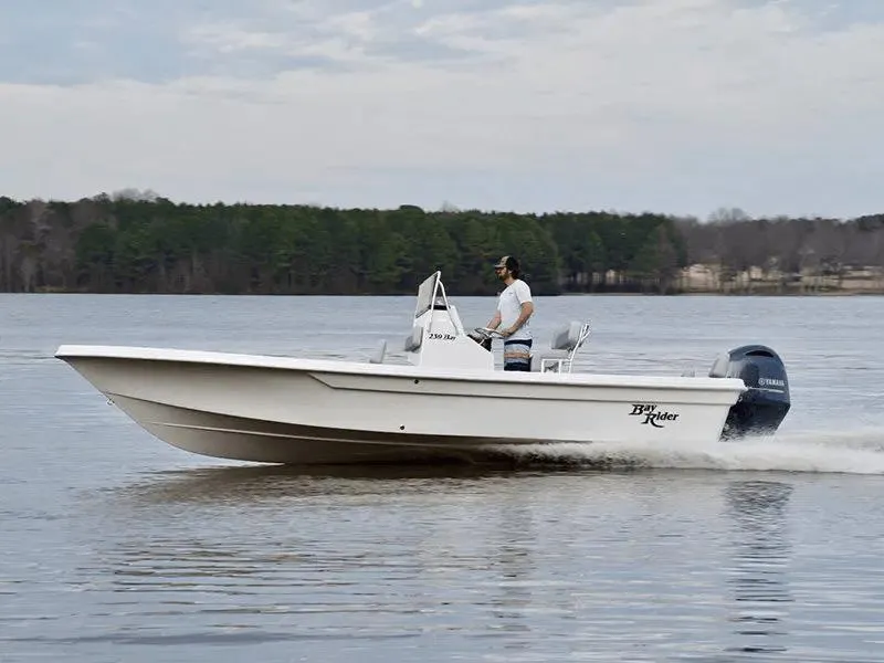 Slide: The Image of 2025 KenCraft 239 Bay Rider Bay boat cruising on a lake. - 4