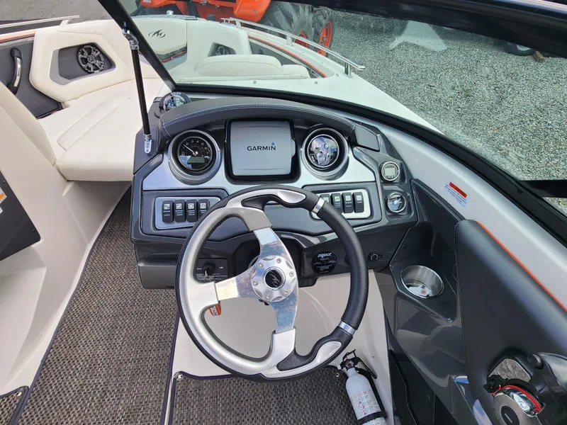 Slide: The Image of 2014 Monterey 234 Super Sport boat dashboard with Garmin navigation system and steering wheel. - 11