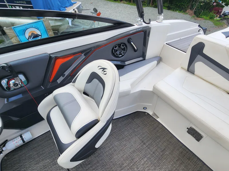 Slide: The Image of Interior of a 2014 Monterey 234 Super Sport boat with white and gray seating. - 12