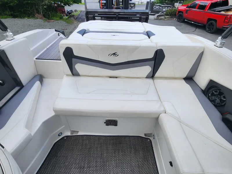 Slide: The Image of 2014 Monterey 234 Super Sport boat interior with white and gray seating. - 13
