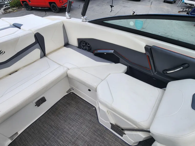 Slide: The Image of 2014 Monterey 234 Super Sport boat interior with white and gray seating. - 15